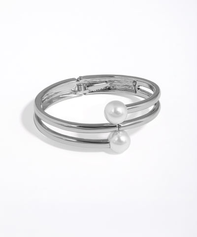 Silver bracelet with pearl accents on a white background