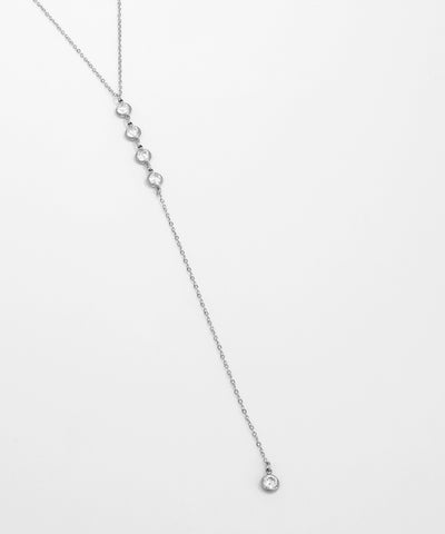 Silver necklace with small beads on a light gray background