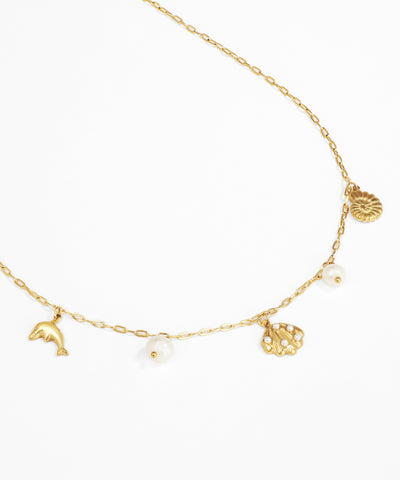 Gold necklace with various charms on a white background