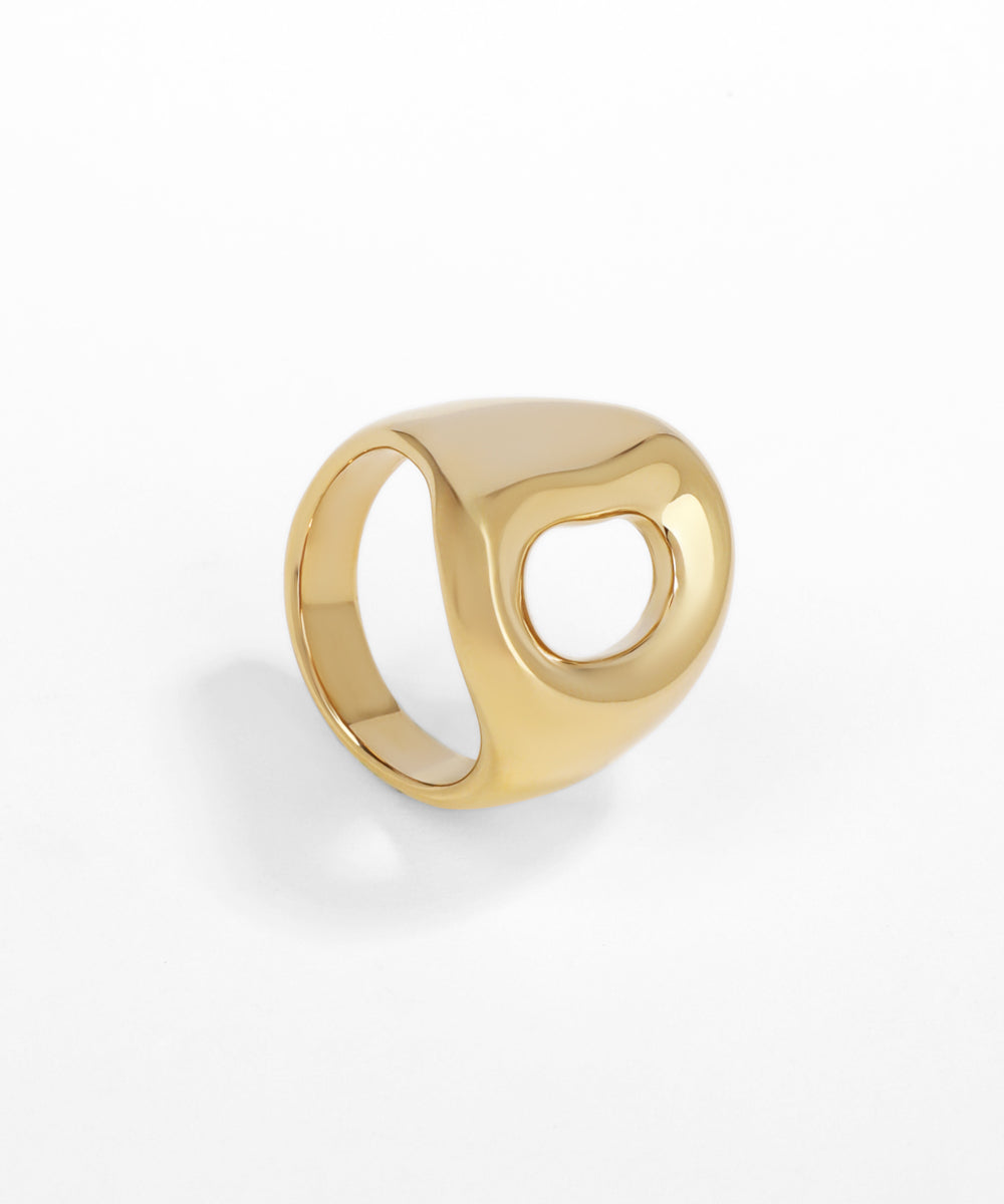 Gold ring with a unique design on a white background