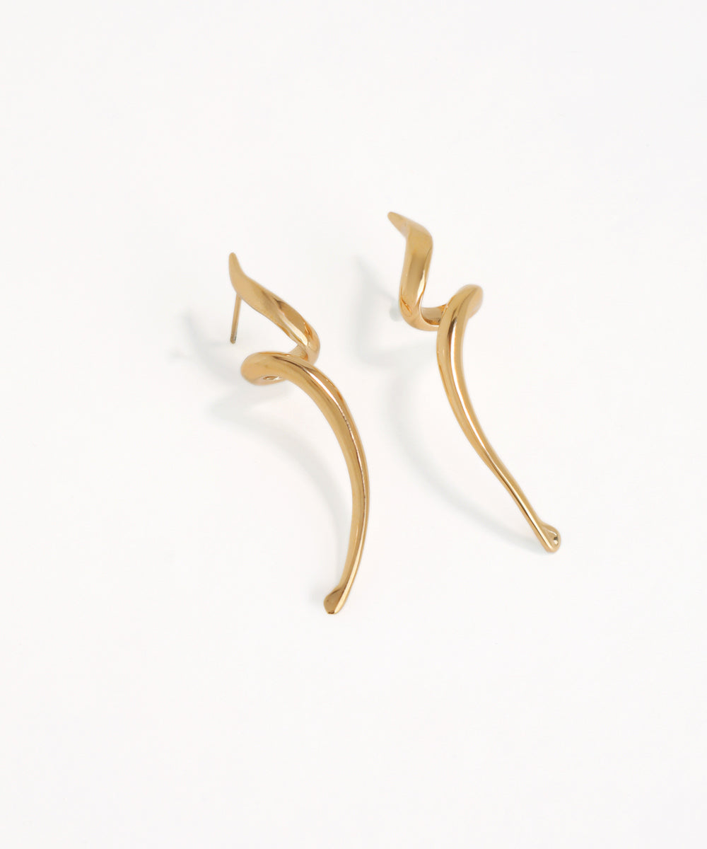 Gold earrings wavy drop on a white background