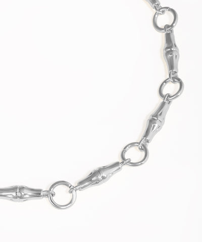 Close-up of a silver chain bracelet on a white background