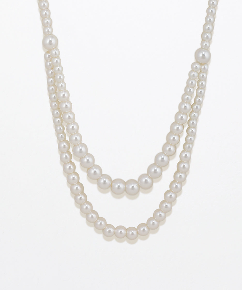 Two-layered pearl necklace on a white background