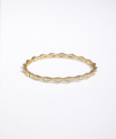 Gold ring with small diamonds on a white background