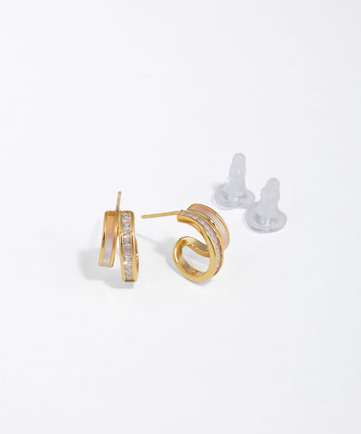 Gold-tone curved stud earrings with faux mother-of-pearl inlay and clear baguette CZ stones.
