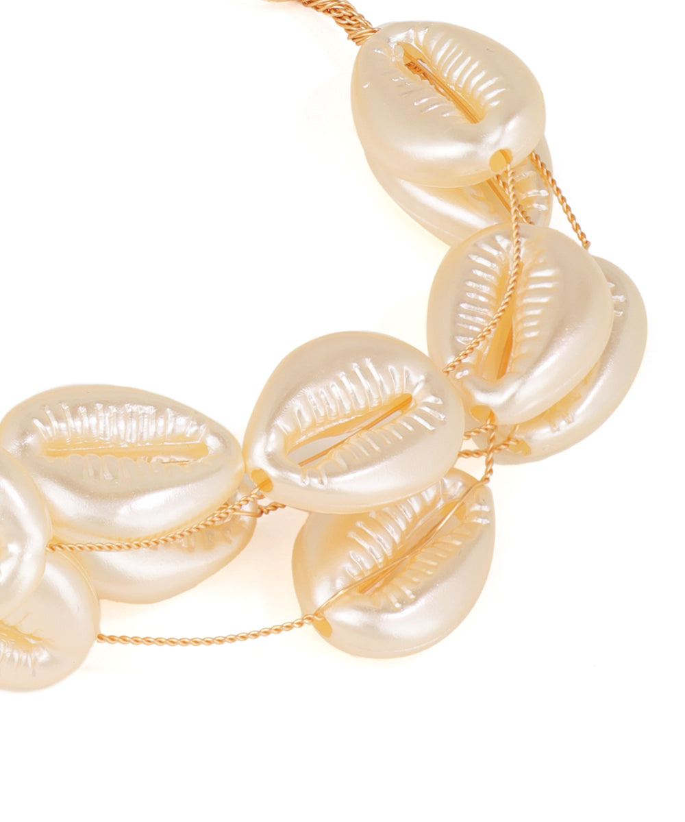 Necklace with large shell-like beads and gold chain on a white background
