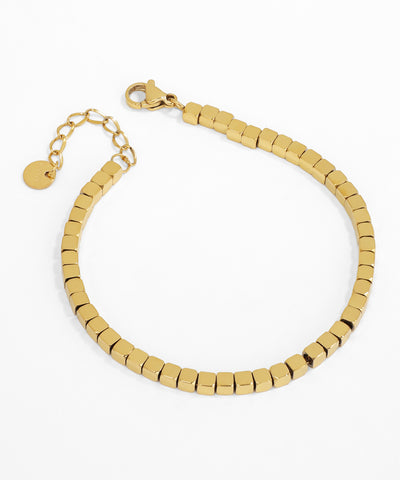 Gold beaded bracelet on a white background