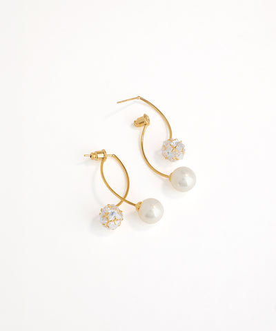 Gold hoop earrings with pearls and crystals on a white background