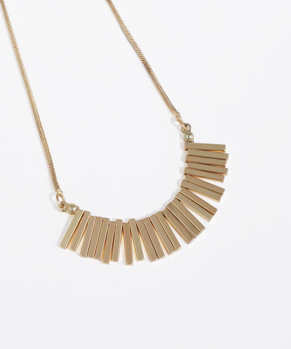 Gold necklace with a fan-shaped pendant on a white background
