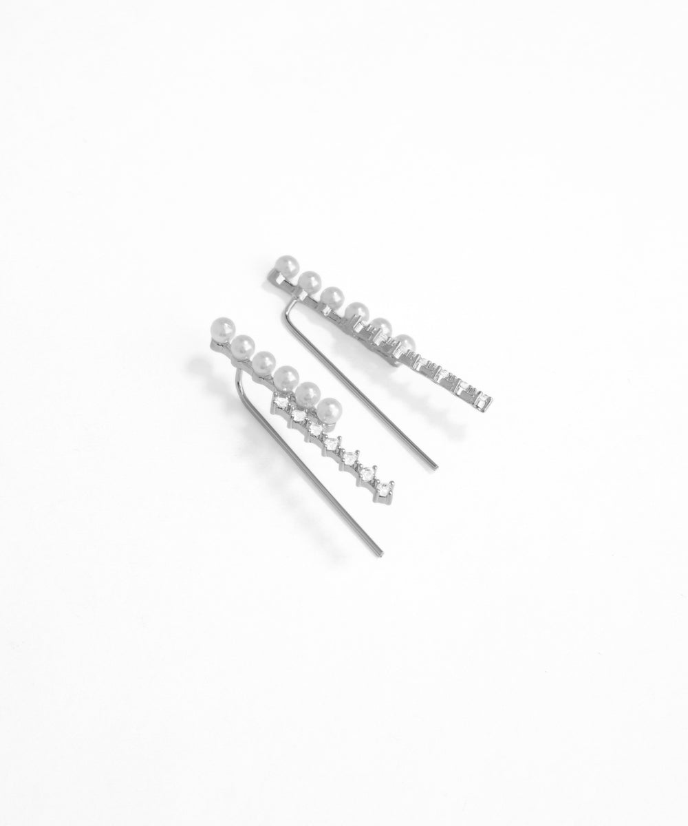 Silver hairpins with star and crown designs on a white background