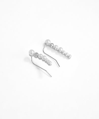 Silver earrings with pearls on a white background