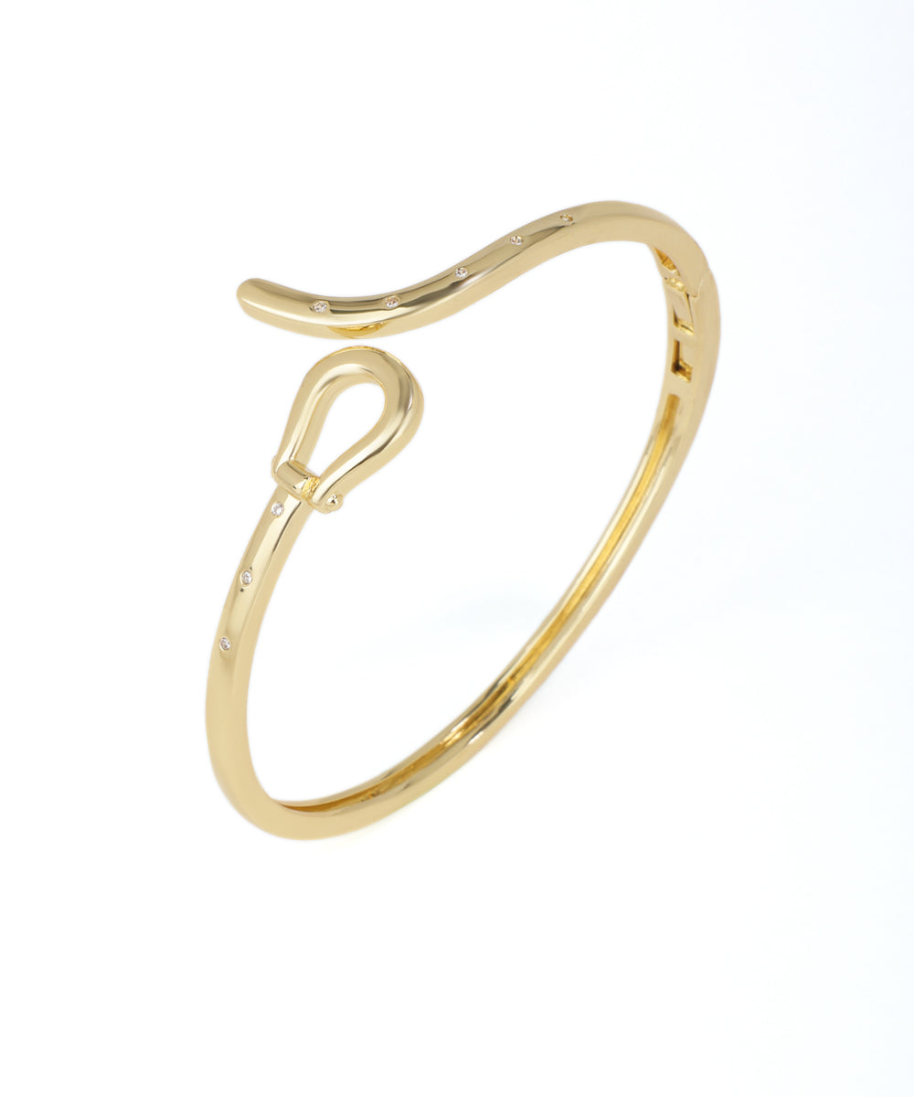 Gold ring with a unique design on a white background