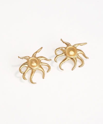 Gold octopus-shaped earrings on a white background