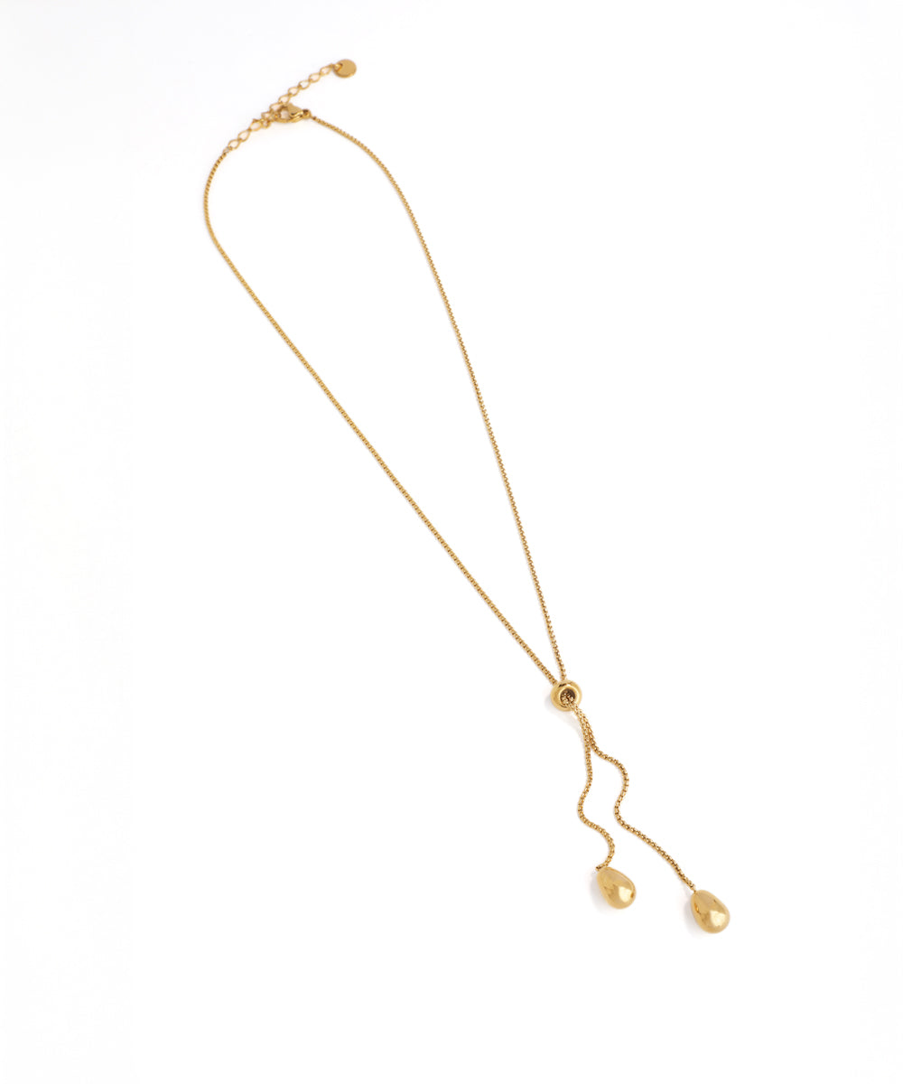 Gold necklace with a pendant on a white background