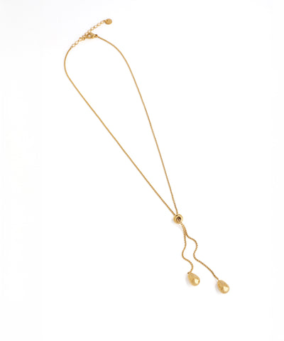 Gold necklace with a pendant on a white background