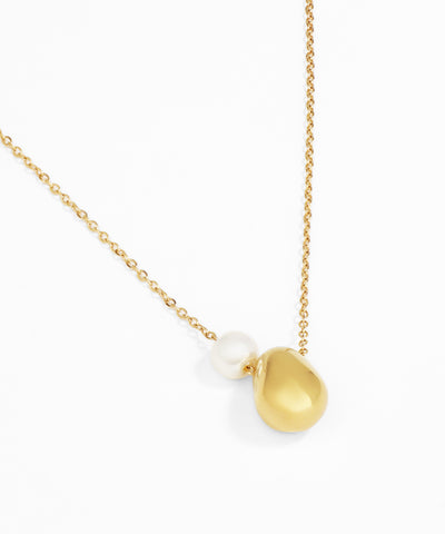 Gold necklace with a teardrop-shaped pendant on a white background
