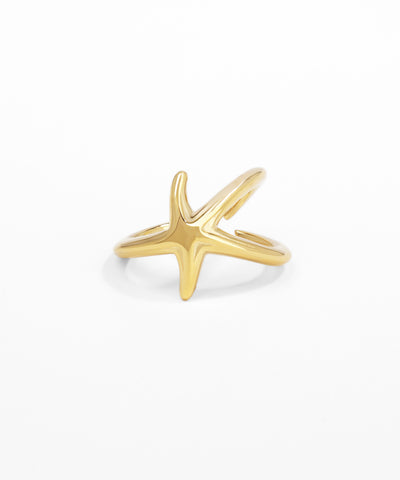 Gold starfish-shaped ring on a white background