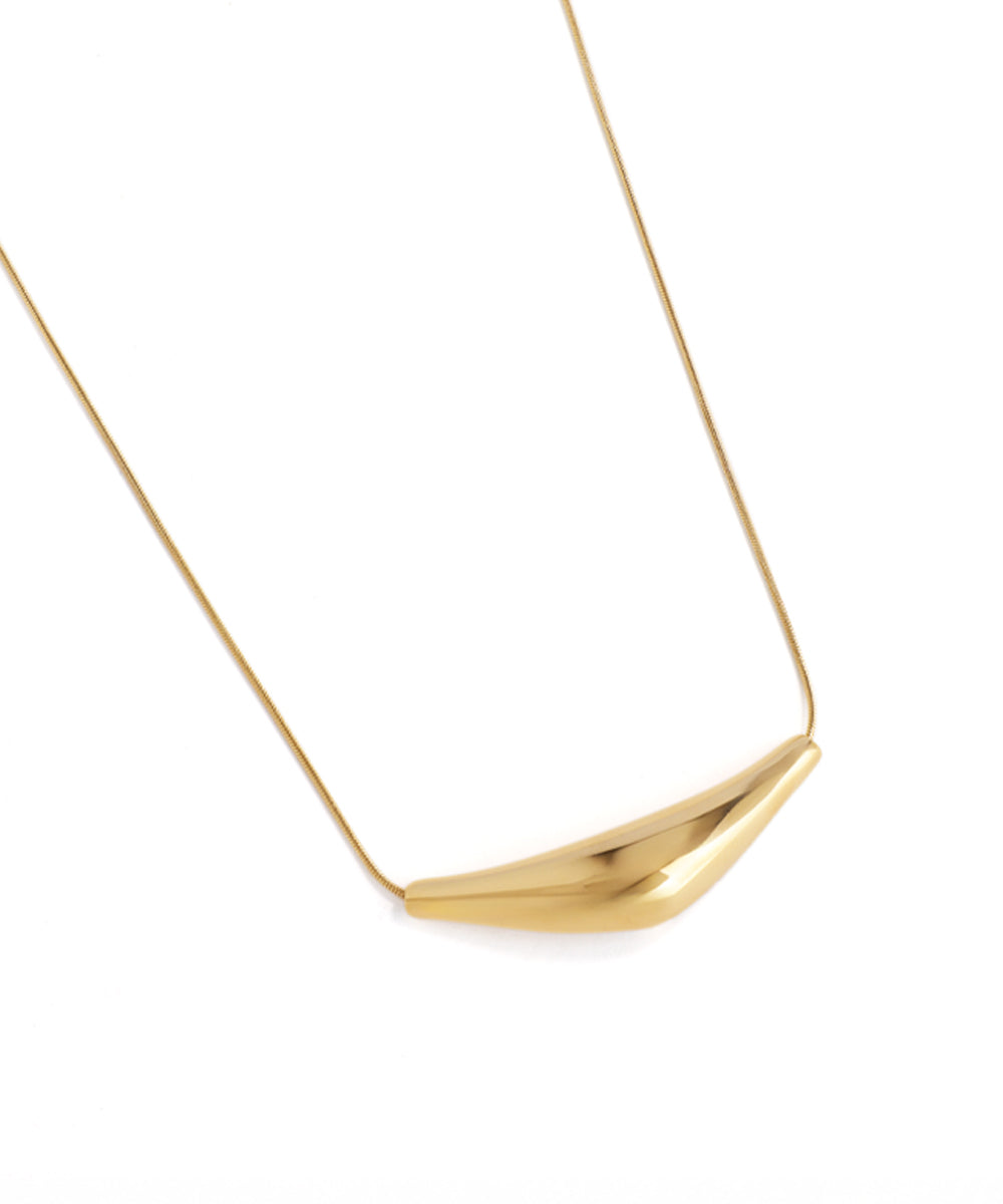 Gold necklace with a modern pendant on a white background