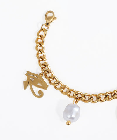 Gold chain bracelet with a pearl charm on a white background