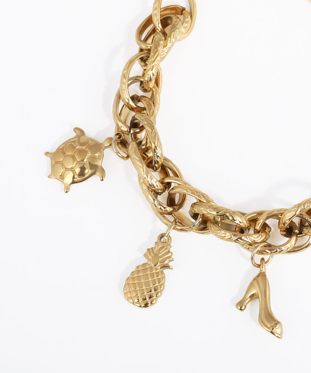 Gold chain bracelet with pineapple and letter 'A' charms on a white background