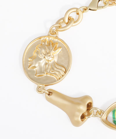 Gold bracelet with various charms on a white background