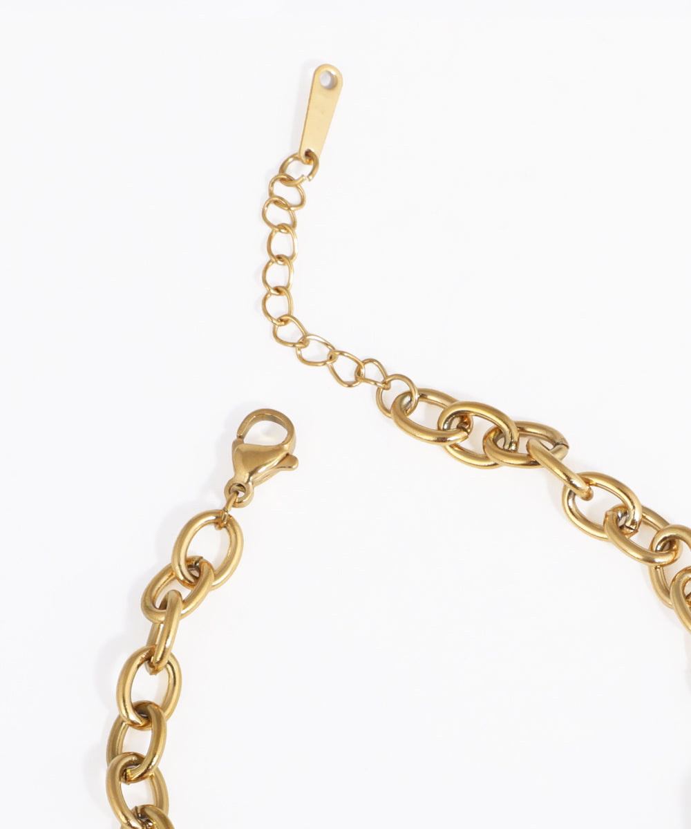 Gold chain bracelet on a white background