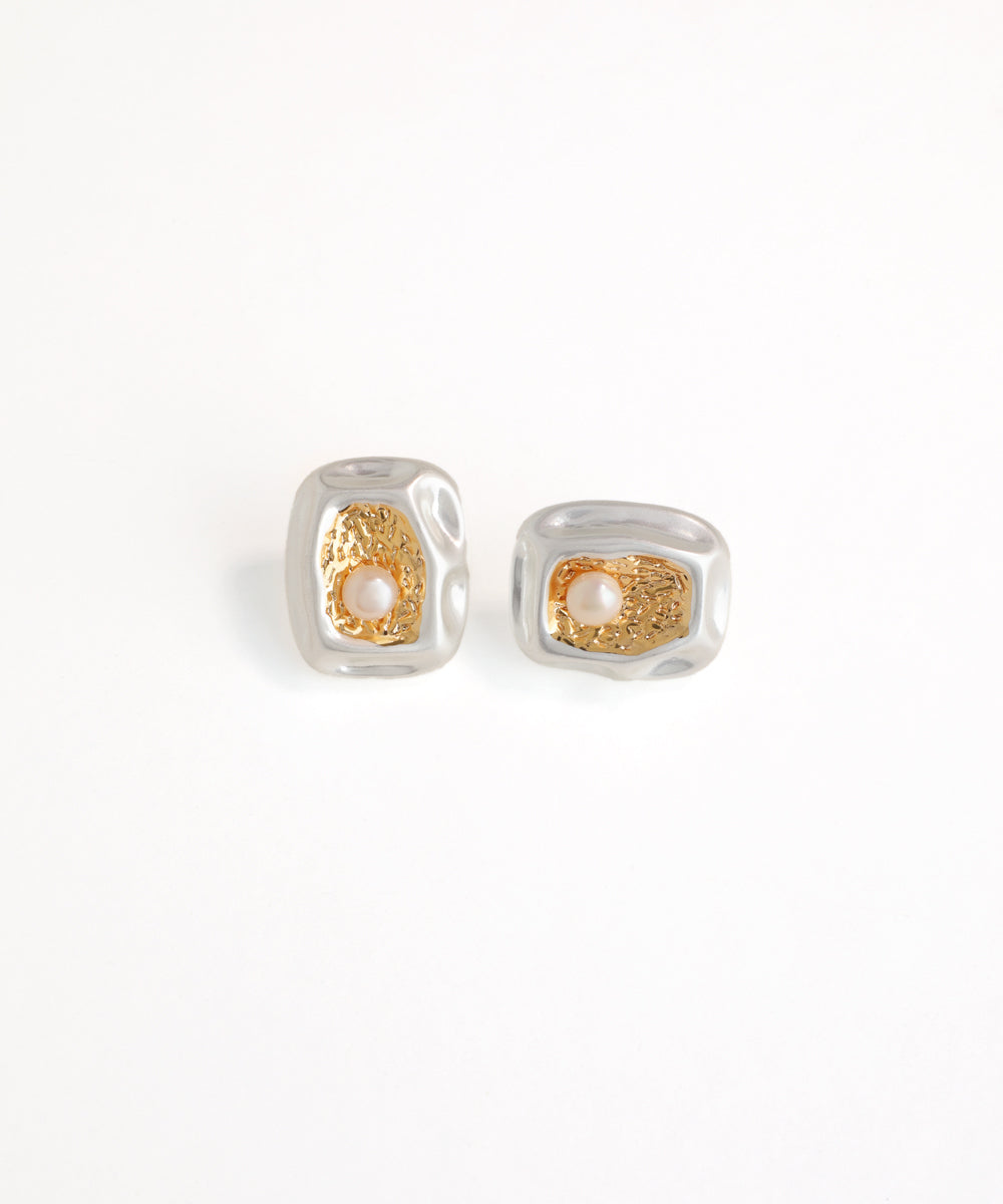 Pair of silver and gold earrings on a white background
