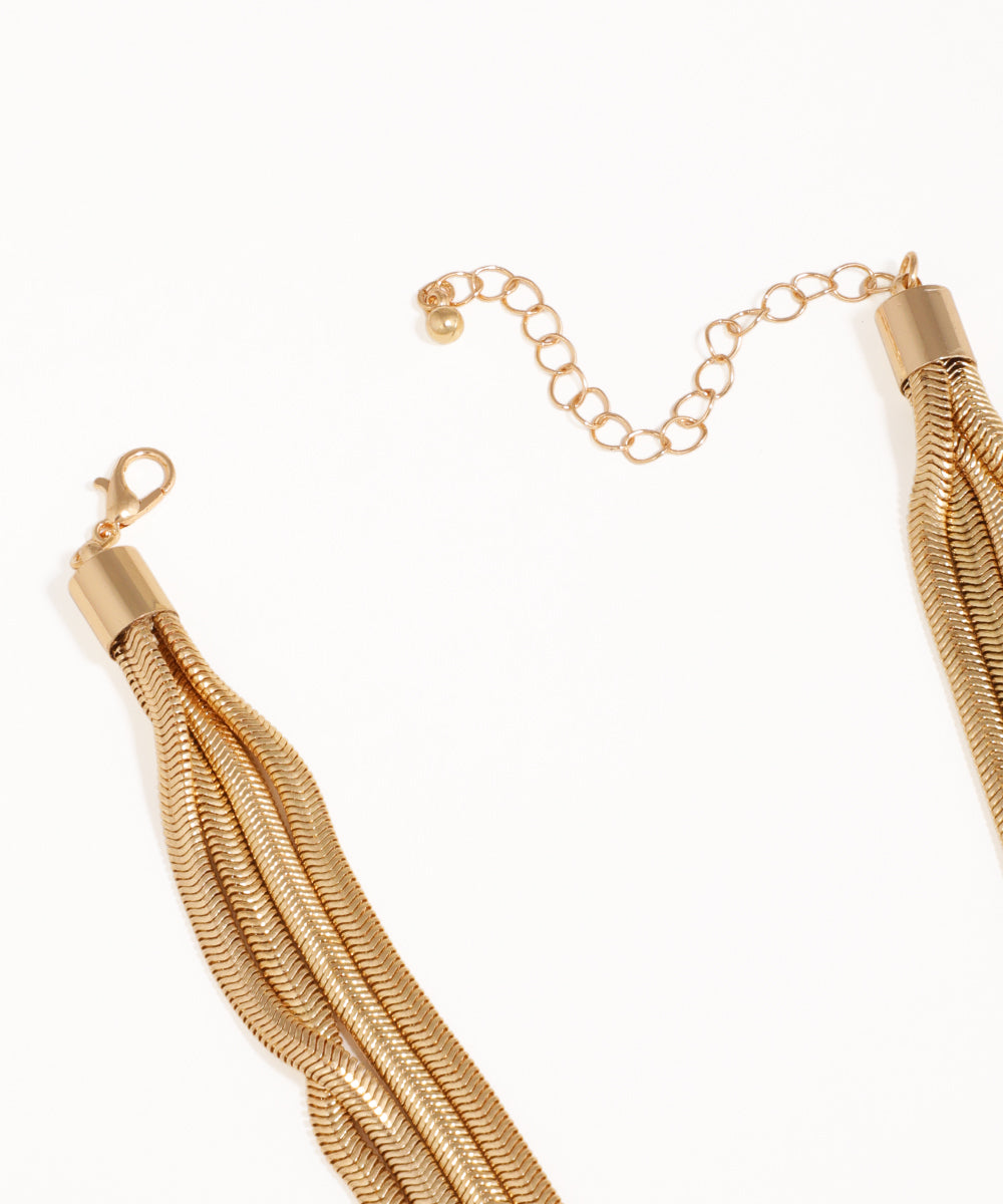 Gold tassel necklace on a white background