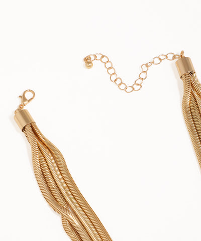 Gold tassel necklace on a white background