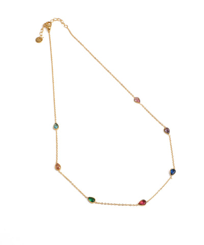 Gold necklace with multicolored gemstones on a white background