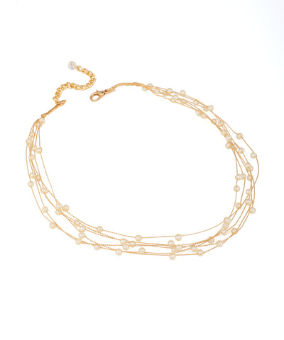 Gold-tone necklace with multiple delicate strands featuring small cream faux pearls and an extender clasp.