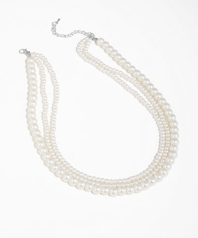Silver-tone necklace with three layered strands of graduated faux pearls.