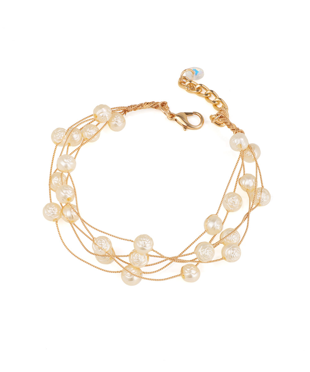 Gold-tone multi-strand bracelet with faux pearls featuring an etched rose design.