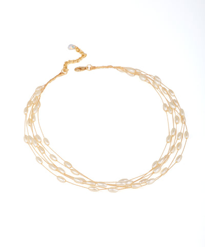 Gold-tone necklace with multiple strands of elongated faux pearls, lobster clasp and extender.