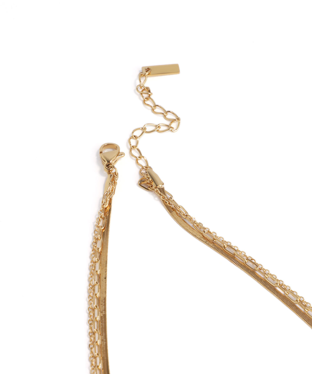 Gold chain necklace on a white background