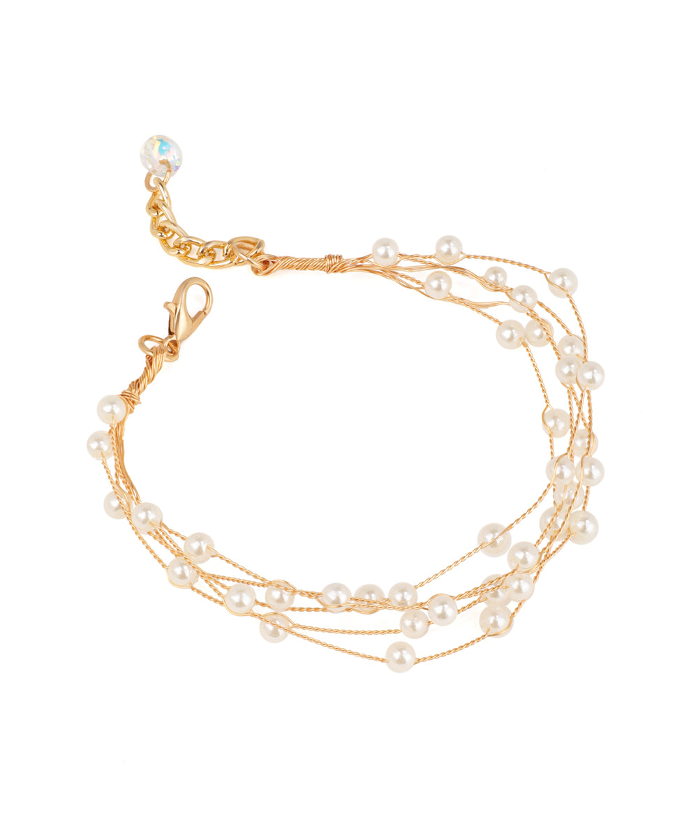 Gold-tone bracelets with multi-strand design and small faux pearls, featuring a lobster clasp.