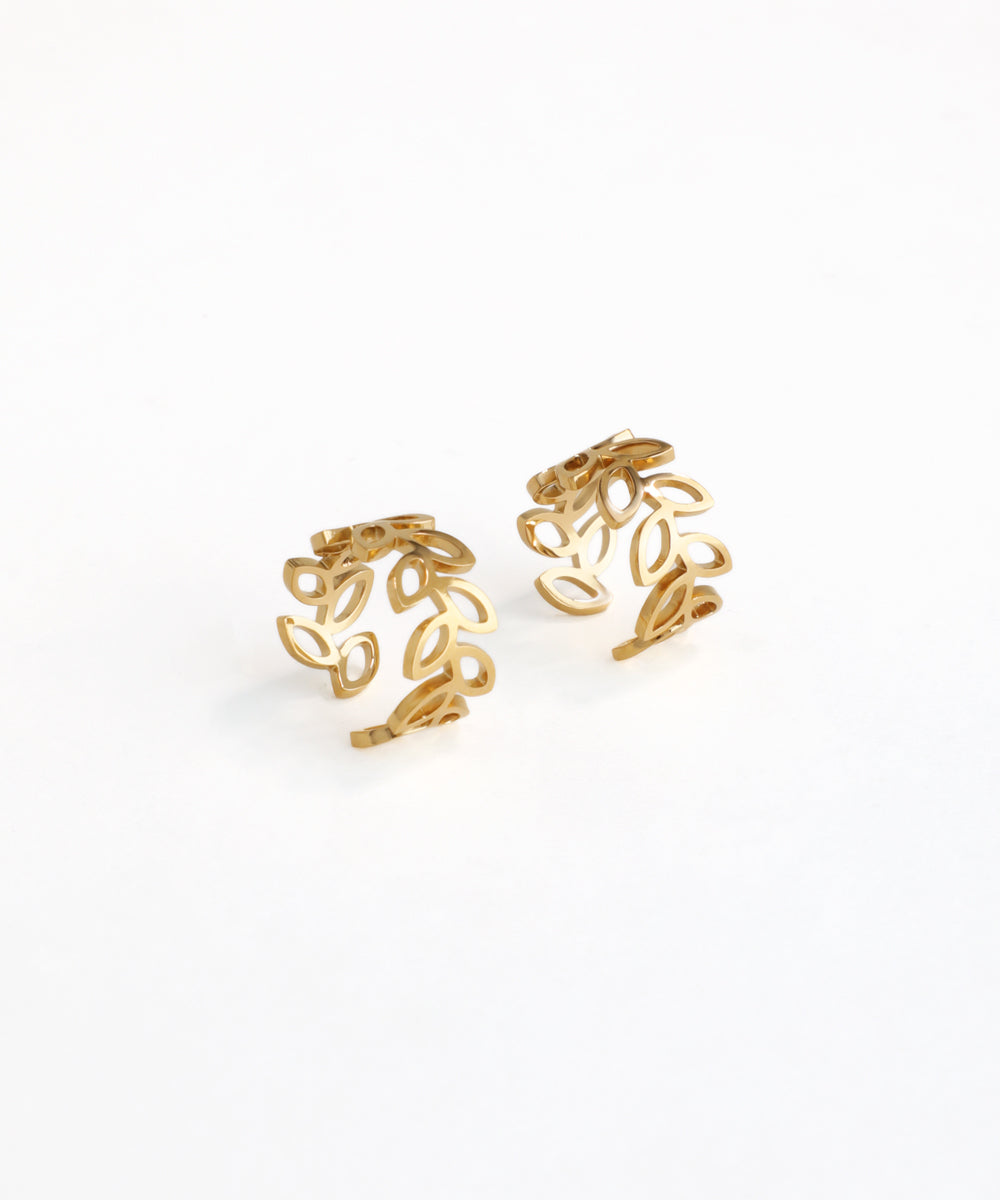 Pair of gold ear cuffs on a white background