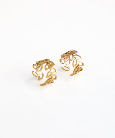 Pair of gold ear cuffs on a white background