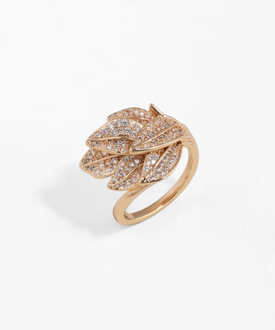 Rose gold ring with leaf design and embedded diamonds on a white background