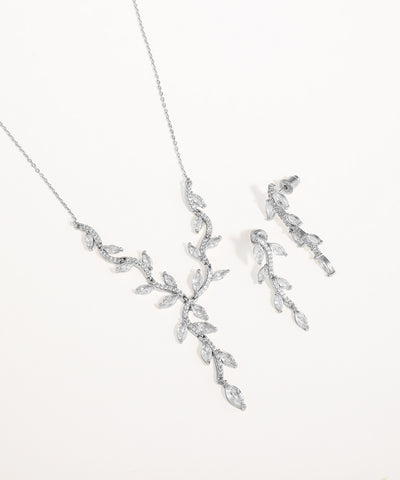 Silver necklace and earrings set on a white background