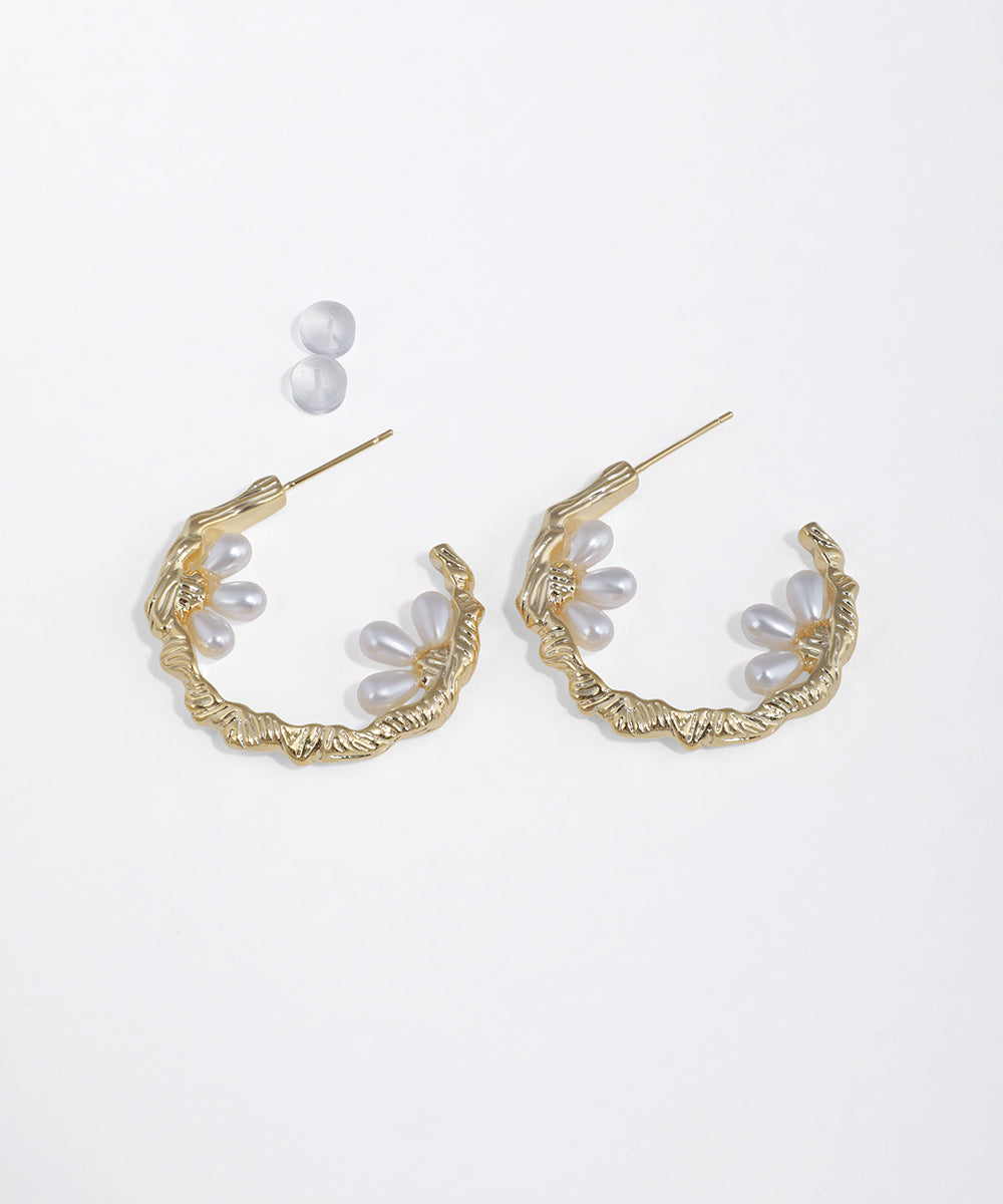 Gold-tone hoop earrings with organic texture and faux pearl floral clusters, secured with push backs.