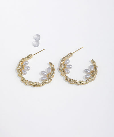 Gold-tone hoop earrings with organic texture and faux pearl floral clusters, secured with push backs.