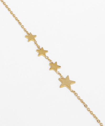 Gold star bracelet on a white background