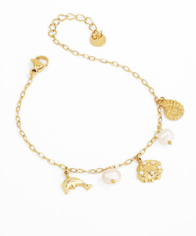 Gold bracelet with various charms on a white background
