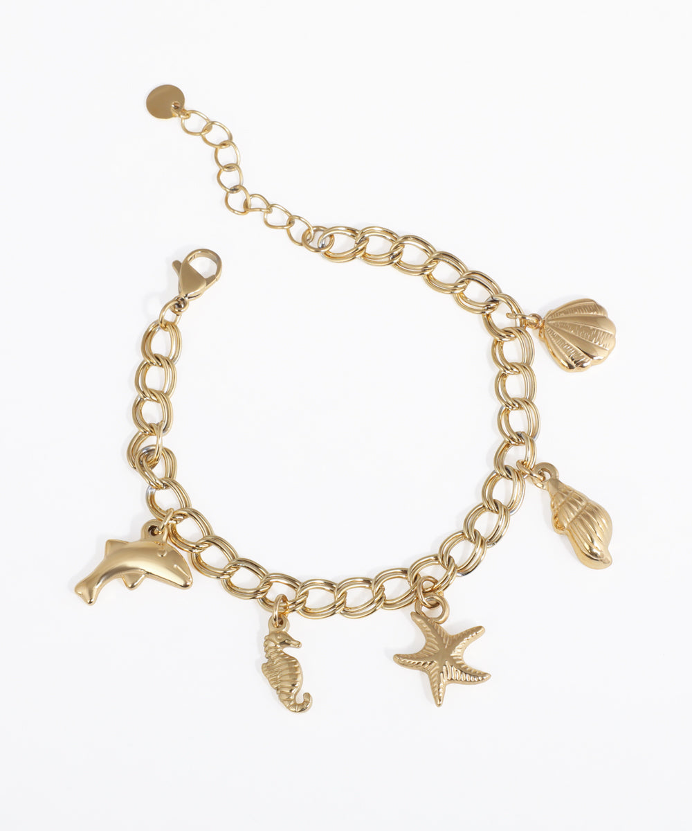 Gold-tone bracelet with sea creature charms including dolphin, seahorse, starfish, and shells