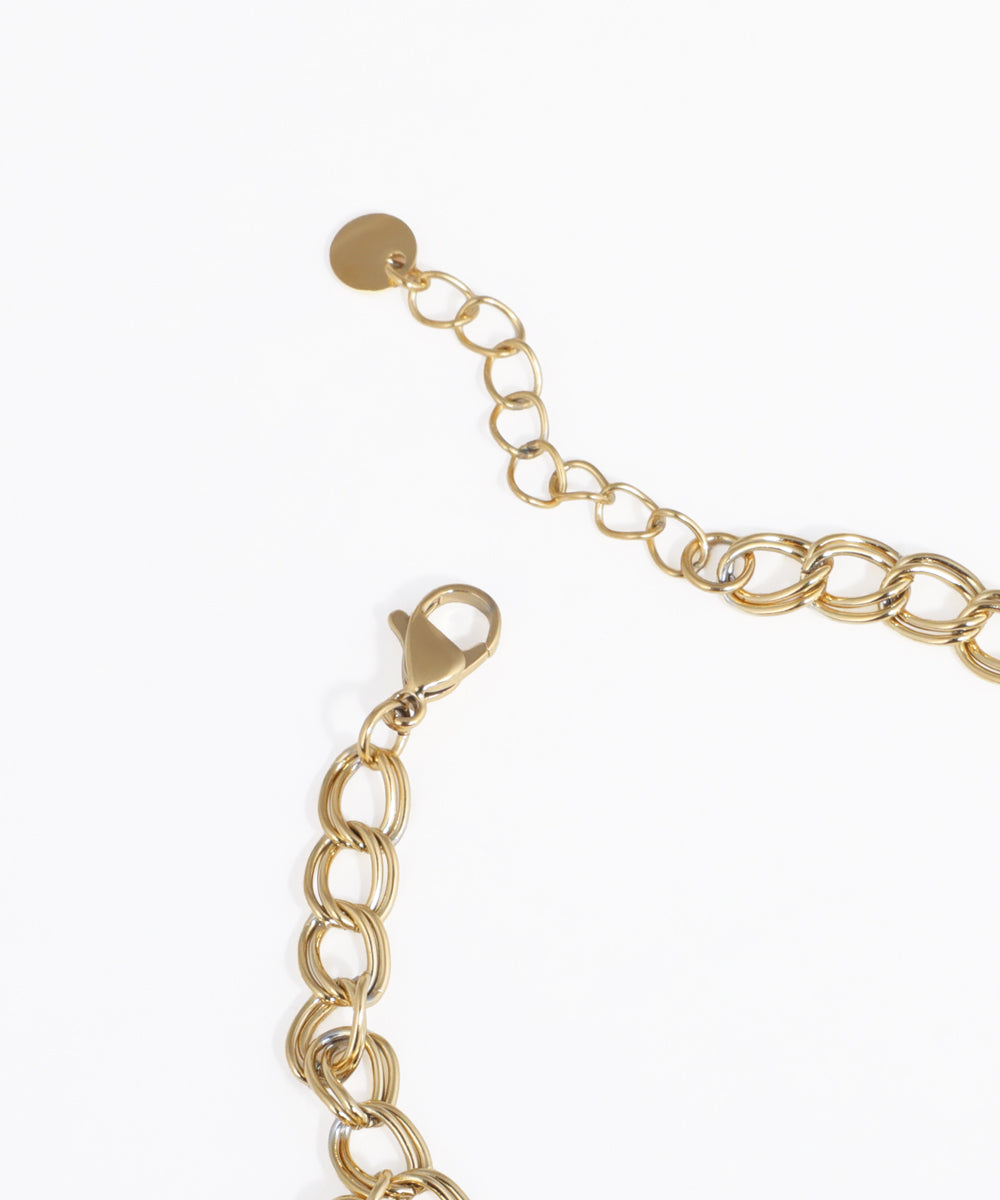 Gold chain bracelet on a white background