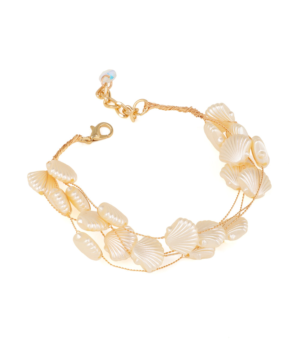 Gold-tone multi-strand bracelet with cream shell-shaped and oval faux beads, lobster clasp