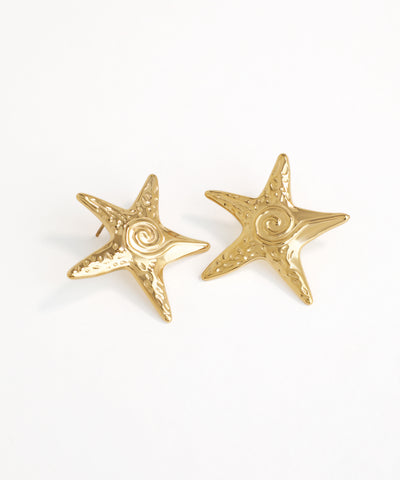 Gold starfish earrings on a white background