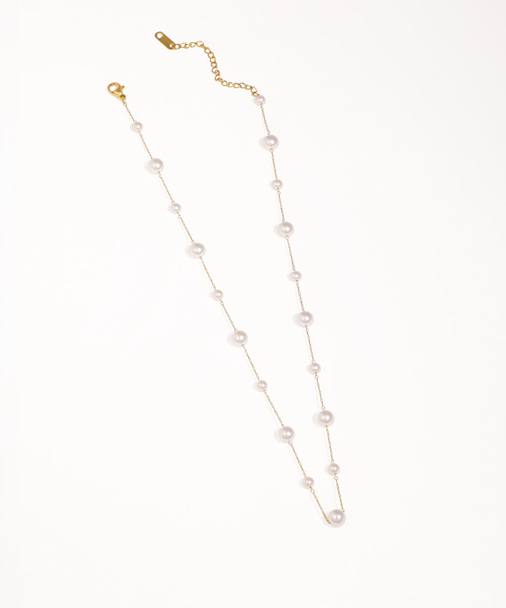 Gold-tone chain necklace with graduated faux pearls