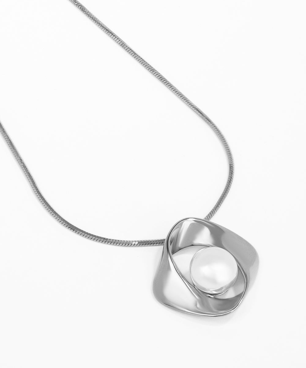 Silver necklace with a unique pendant on a white background